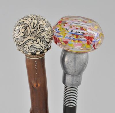 Appraisal: Two Walking Sticks with Decorative Knobs The first made of