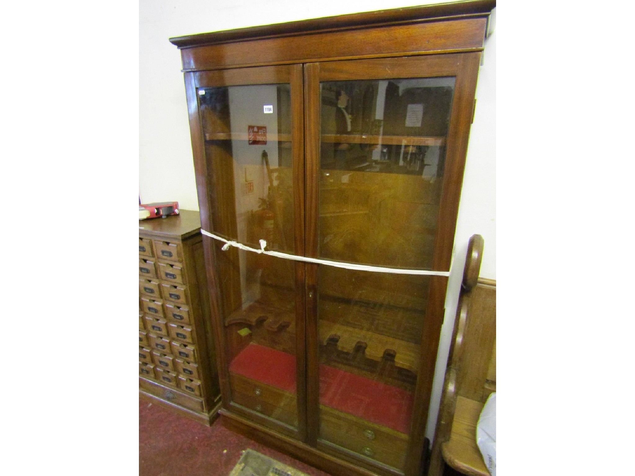 Appraisal: A freestanding mahogany side cabinet with moulded cornice over a