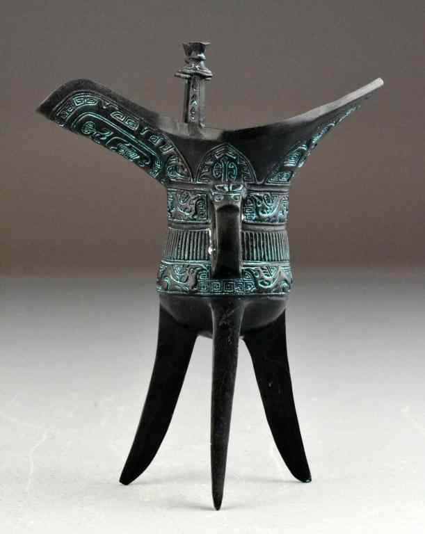 Appraisal: Chinese Bronze Ju VesselOf archaic form and design raised on