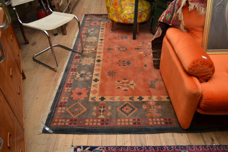 Appraisal: A CONTEMPORARY FLOOR RUG IN ORANGE AND GREEN PATTERNS