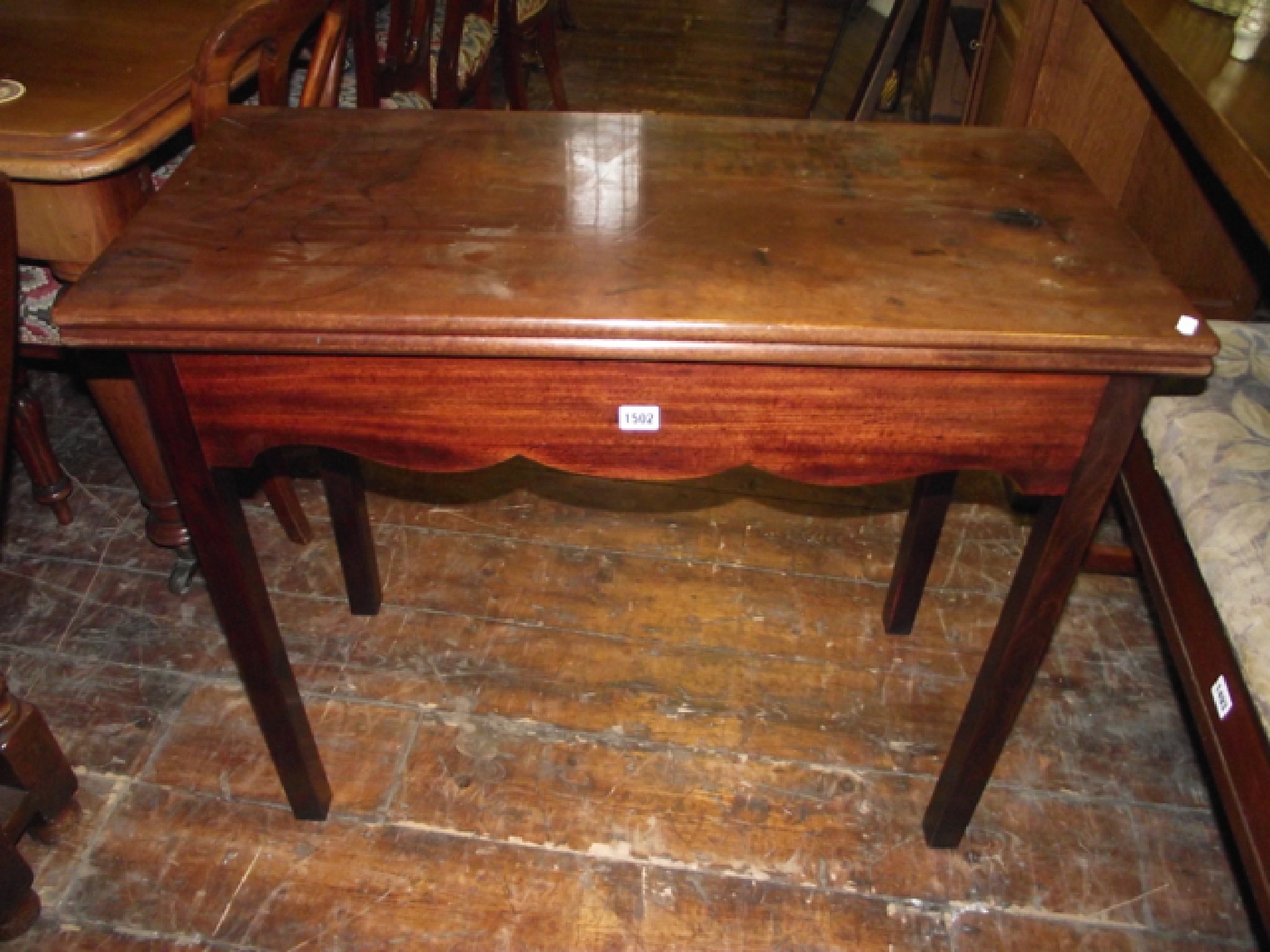 Appraisal: A simple Georgian mahogany fold over top tea table of