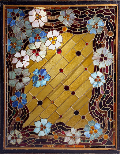 Appraisal: ARTS AND CRAFTS Leaded-glass window with stylized blossoms on a