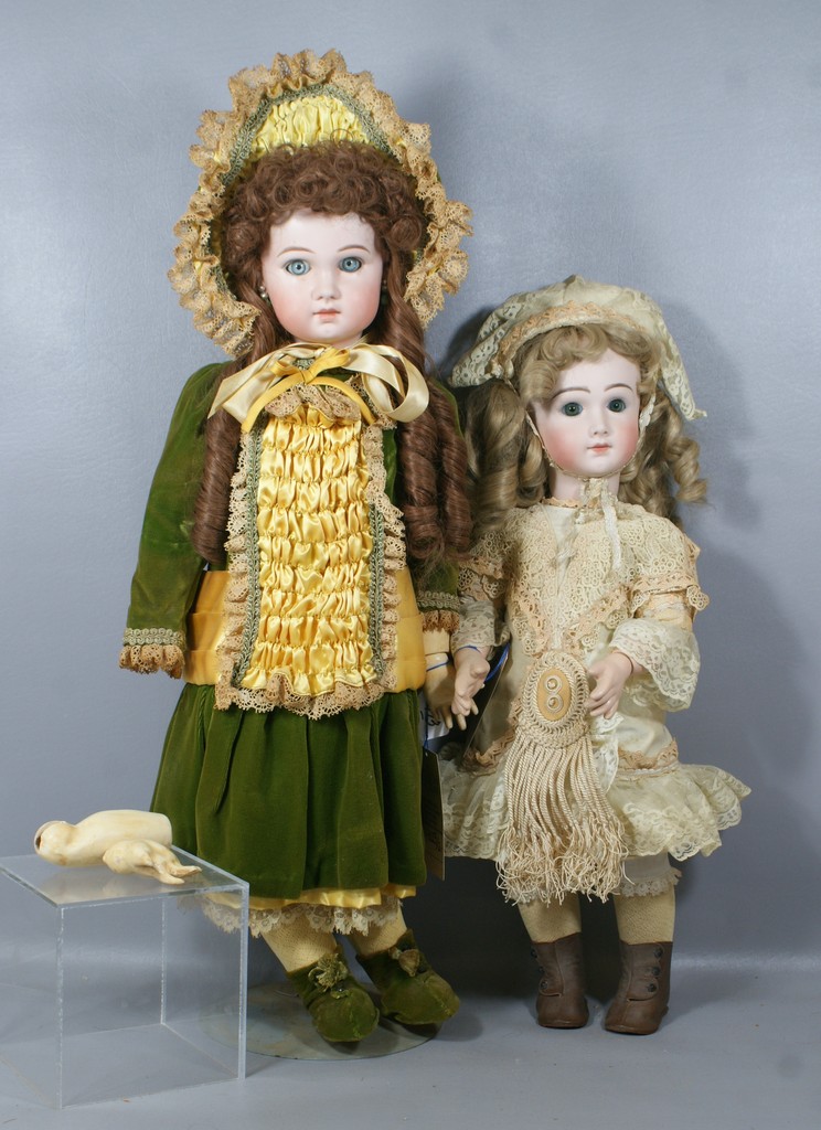 Appraisal: Reproduction French Dolls the larger in a green dress represents