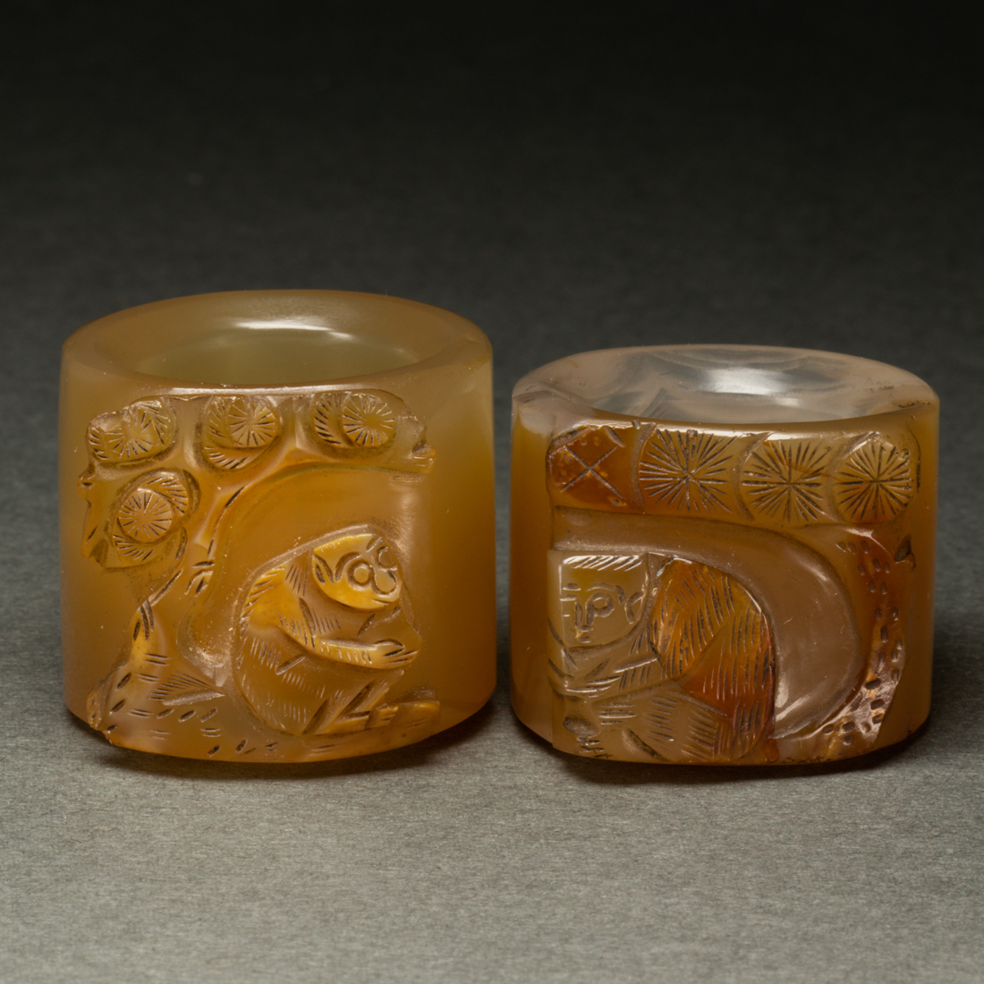 Appraisal: PAIR OF CHINESE AGATE 'MONKEY AND PINE' ARCHER'S RINGS Pair