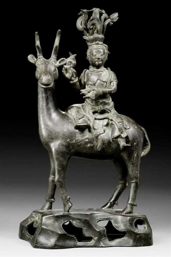 Appraisal: A BRONZE IMMORTAL WITH A LOTUS BASKET RIDING ON A