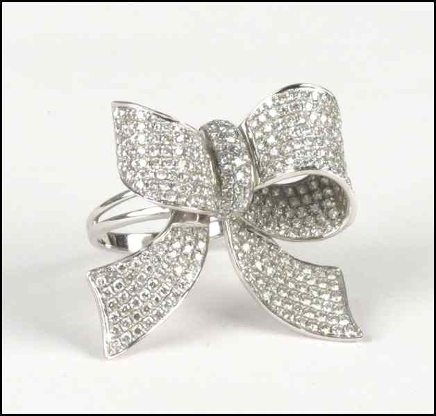 Appraisal: KARAT WHITE GOLD AND PAVE DIAMOND BOW KNOT FORM RING