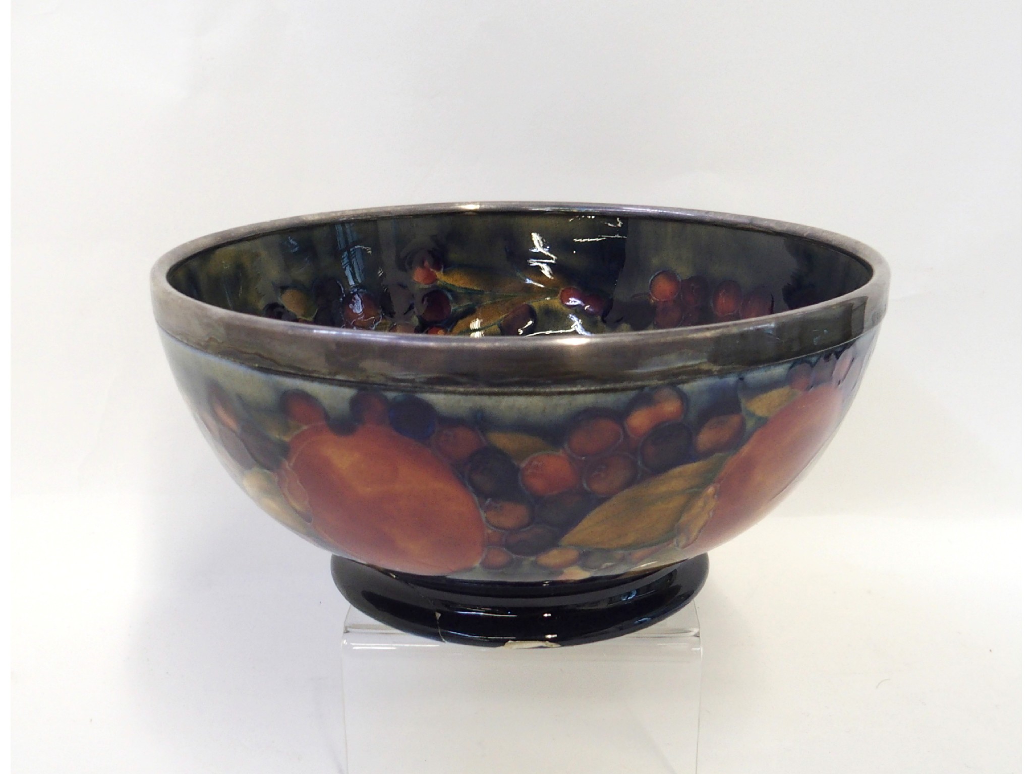 Appraisal: A Moorcroft Pomegranate pattern bowl with silver rim def