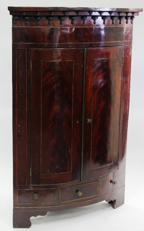 Appraisal: An early th Century mahogany bowfront corner cupboard with moulded