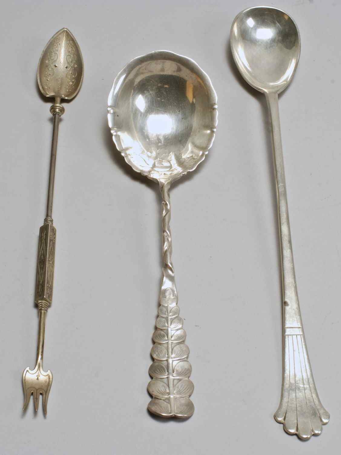 Appraisal: THREE STERLING SILVER SERVING PIECESA berry spoon by Whiting Div