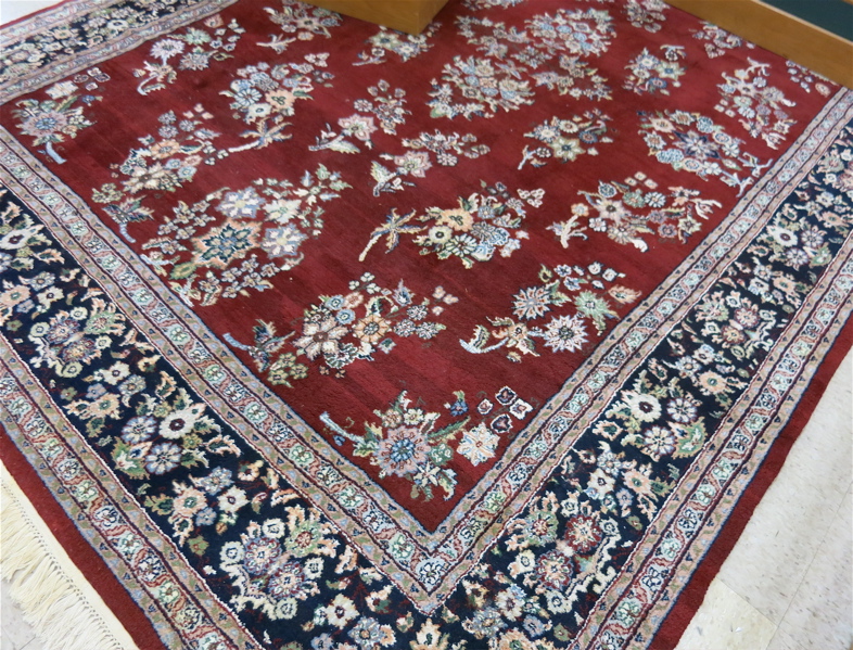 Appraisal: HAND KNOTTED ORIENTAL CARPET Indo-Sarouk the red wine ground decorated