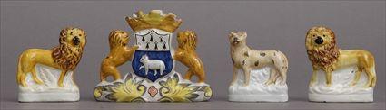 Appraisal: PAIR OF STAFFORDSHIRE FIGURES OF LIONS AN ARMORIAL VASE AND