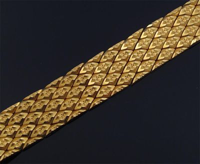 Appraisal: A gold strap bracelet with foliate decoration g cm long