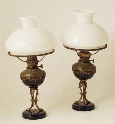 Appraisal: A pair of earthenware and gilt brass table lamps converted