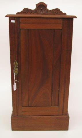 Appraisal: A small antique walnut one door cupboard carved back trim