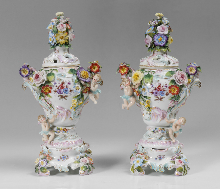 Appraisal: PAIR DRESDEN STYLE COVERED URNS Nearly mirror image pair with