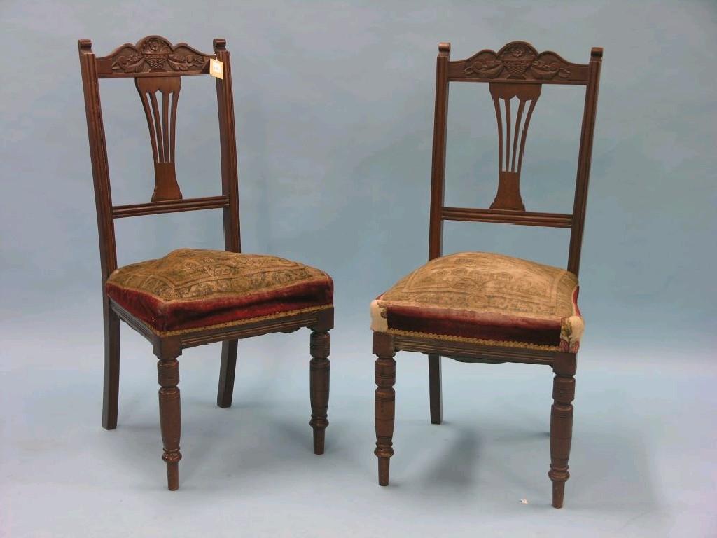 Appraisal: A set of four Edwardian carved walnut dining chairs with