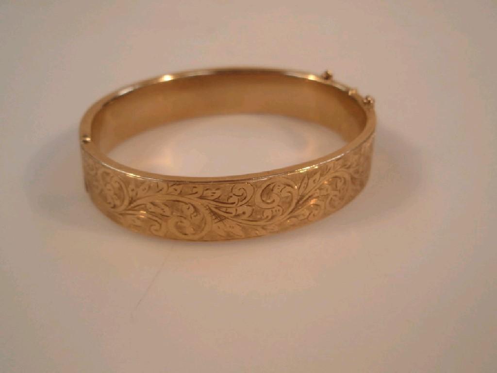 Appraisal: A bangle a hollow hinged ct gold bangle with engraved