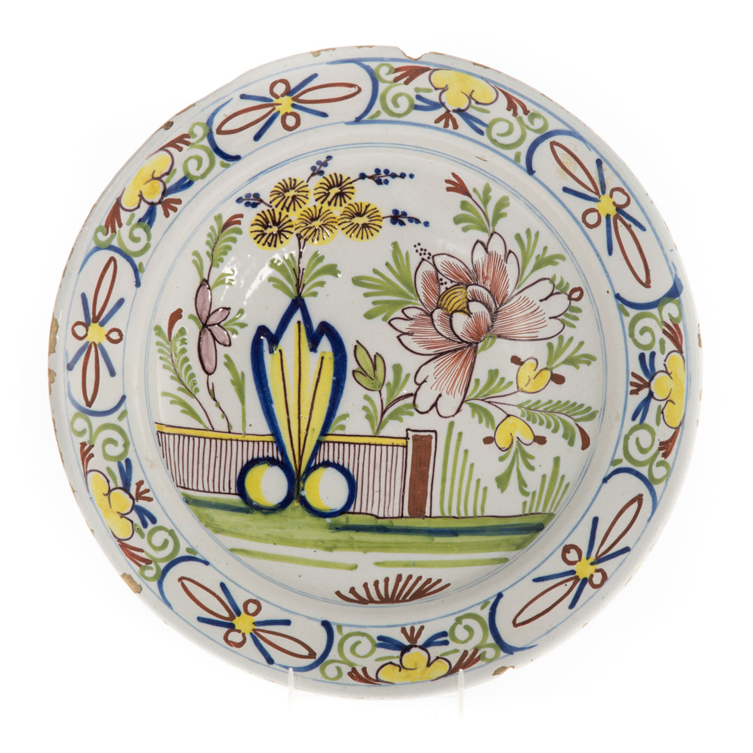 Appraisal: Liverpool polychrome delftware charger circa with floral and garden wall