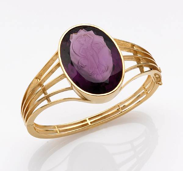 Appraisal: A carved amethyst bangle bracelet the oval-shaped amethyst measuring approximately