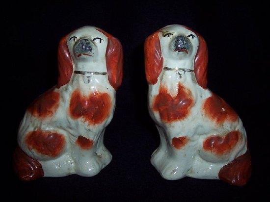 Appraisal: A pair of Staffordshire liver and white dogs with gilt