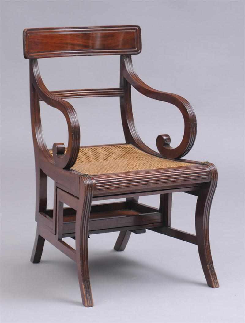 Appraisal: REGENCY CARVED MAHOGANY METAMORPHIC LIBRARY ARMCHAIR With tablet crest rail