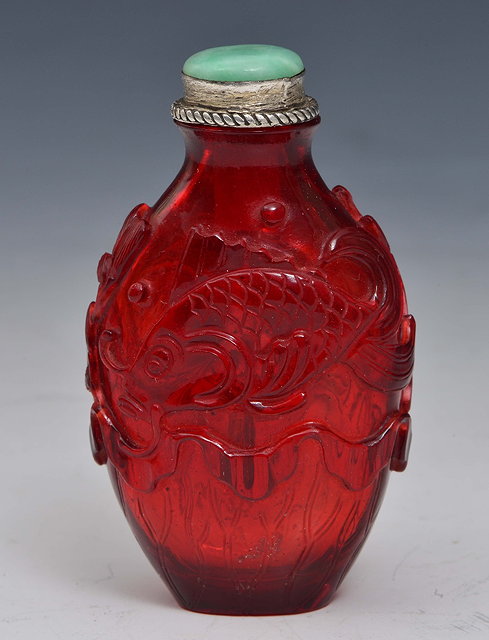 Appraisal: A CHINESE OVOID FORM RED GLASS SNUFF BOTTLE carved in