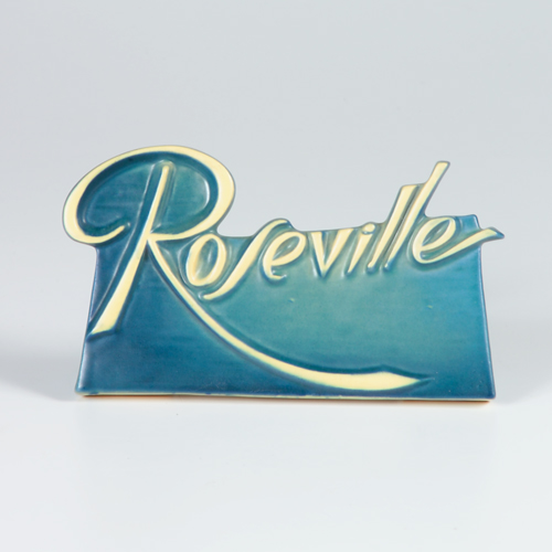 Appraisal: ROSEVILLE Dealer's sign with ivory scrolled letters on a blue