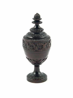 Appraisal: A late th century turned and carved treen vase and