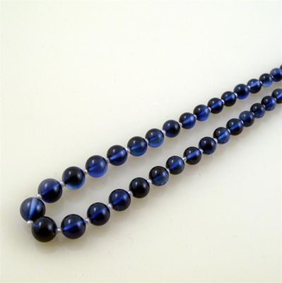 Appraisal: A graduated blue stone bead necklace Possibly synthetic sapphire The