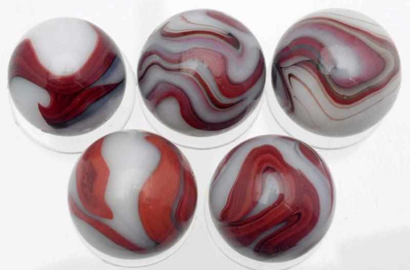 Appraisal: Lot of Akro White Oxblood Marbles White base marbles with