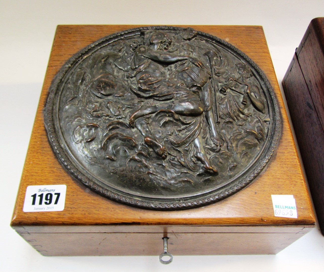 Appraisal: A square oak lift top box with embossed circular metal