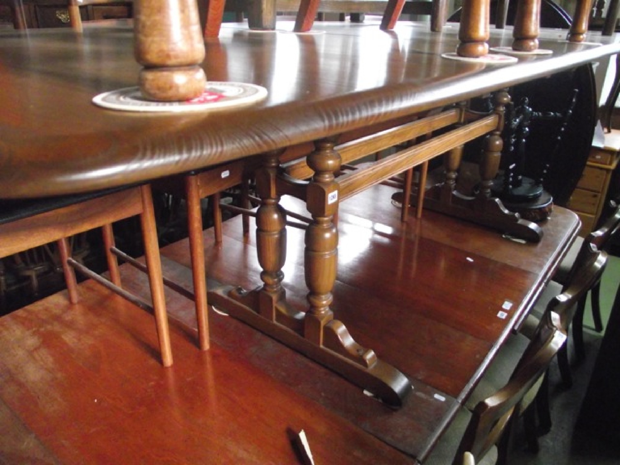 Appraisal: A contemporary Ercol medium elm pull out extending dining table