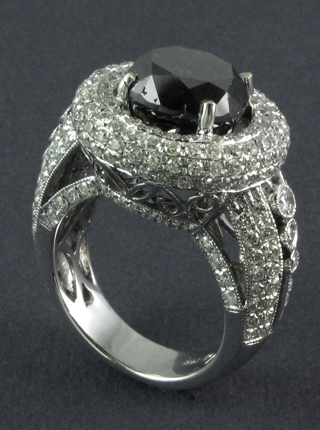 Appraisal: BLACK DIAMOND AND FOURTEEN KARAT GOLD RING centering a round