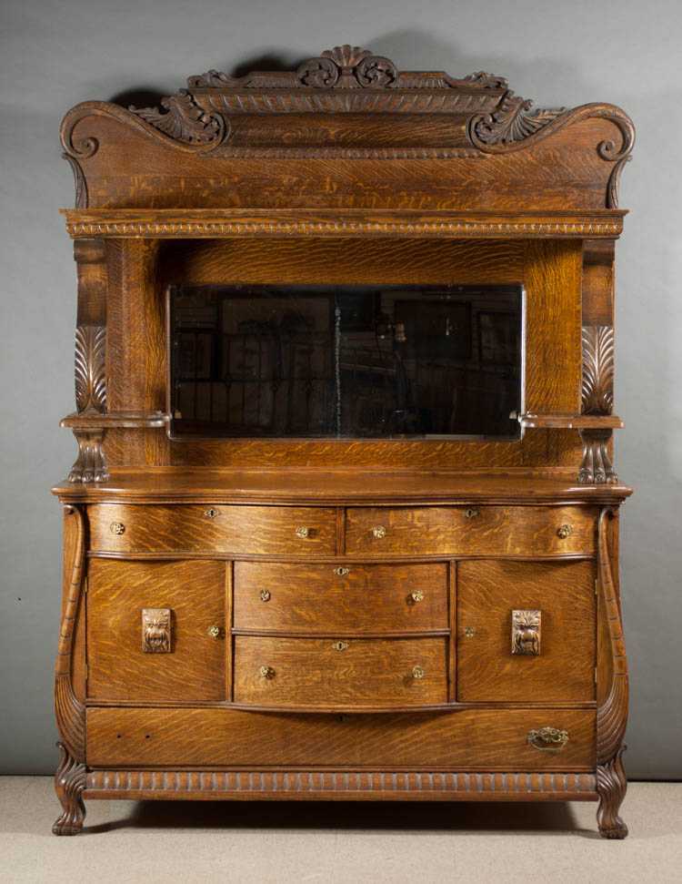 Appraisal: LATE VICTORIAN CARVED OAK SIDEBOARD American c featuring a mirror