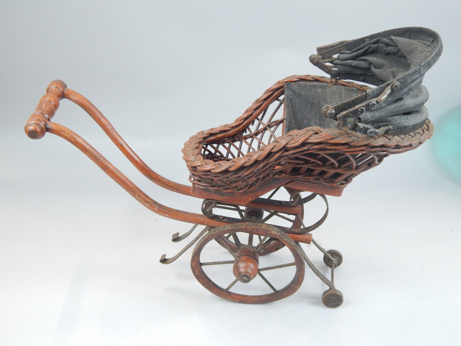 Appraisal: A reproduction Victorian bath chair or pram with canvas hood