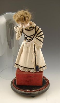 Appraisal: An automaton doll with a musical movement to the plush