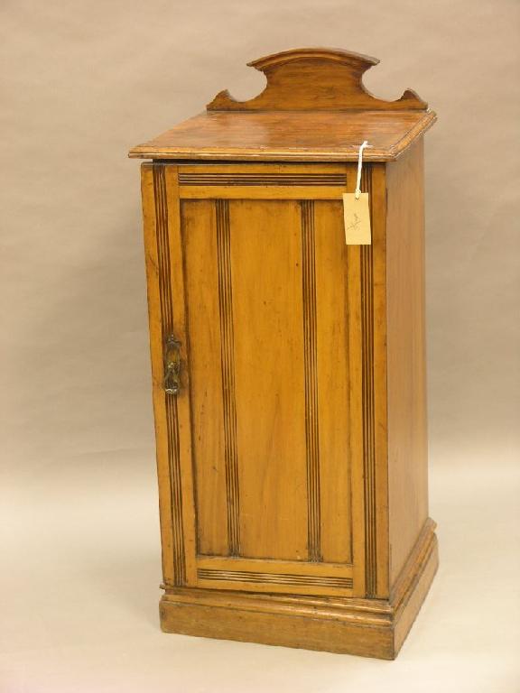 Appraisal: A Victorian satin birch bedside cupboard enclosed by single door