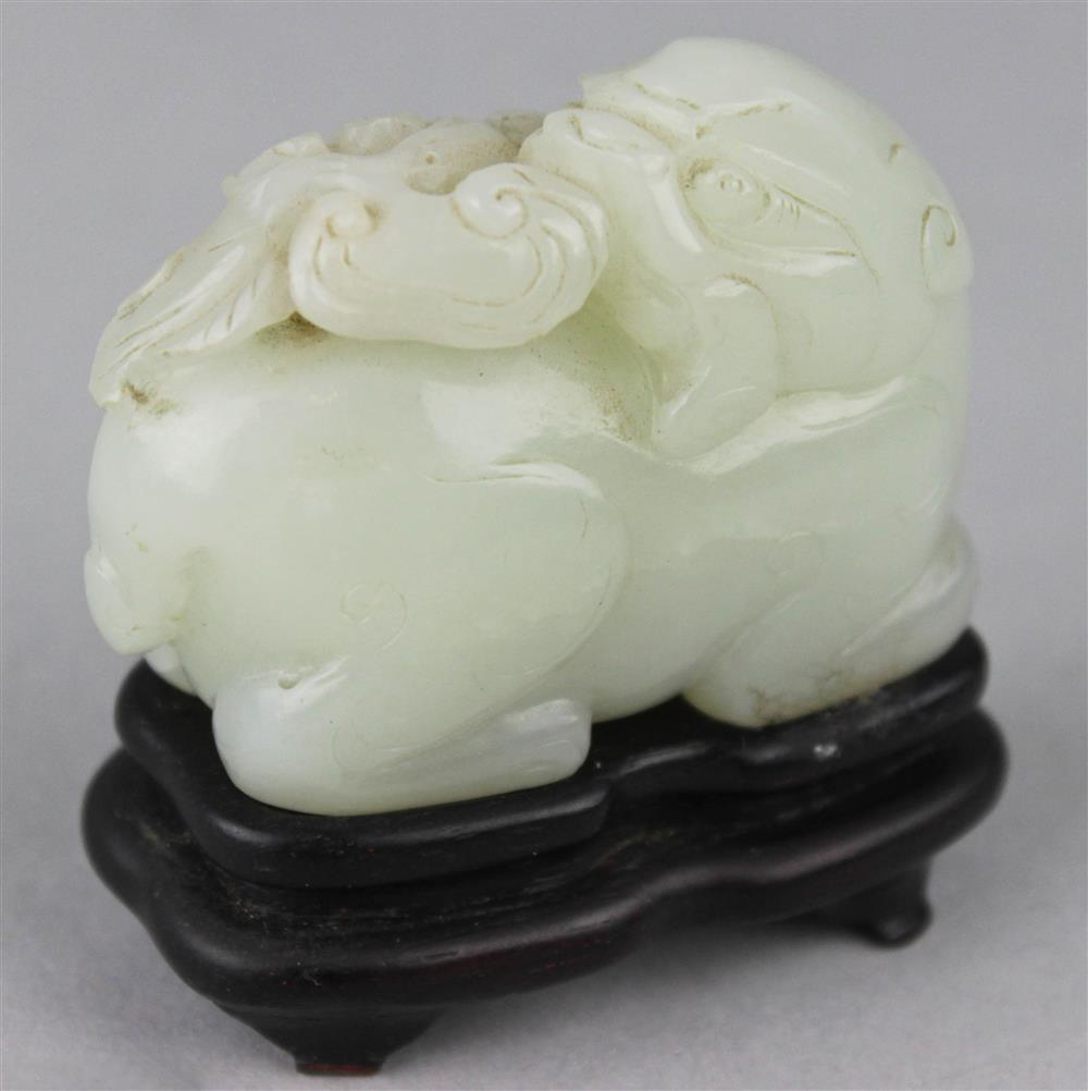 Appraisal: CHINESE WHITE JADE CARVING OF A CROUCHING QILONG WITH FUNGUS