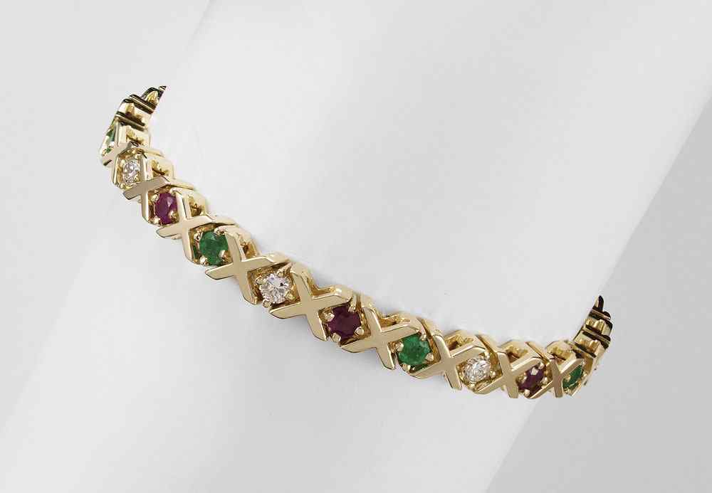 Appraisal: K YELLOW GOLD DIAMOND EMERALD AND RUBY BRACELET X O