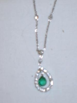 Appraisal: A DIAMOND AND EMERALD PENDANT with emerald suspended in diamond