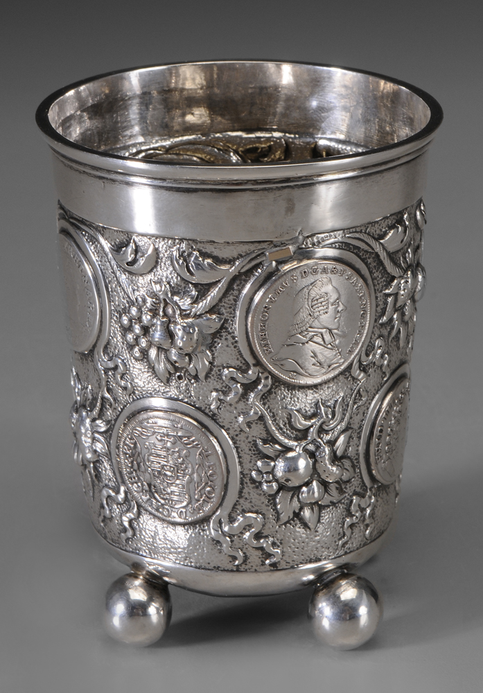 Appraisal: German Silver Beaker repousse floral and fruit decoration ball feet