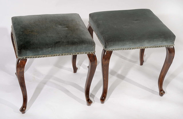 Appraisal: A PAIR OF SQUARE OVERSTUFFED BLUE UPHOLSTERED STOOLS standing on