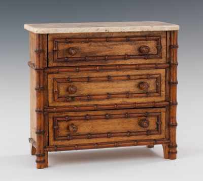 Appraisal: A Miniature Chest of Drawers with Travertine Top Honey color