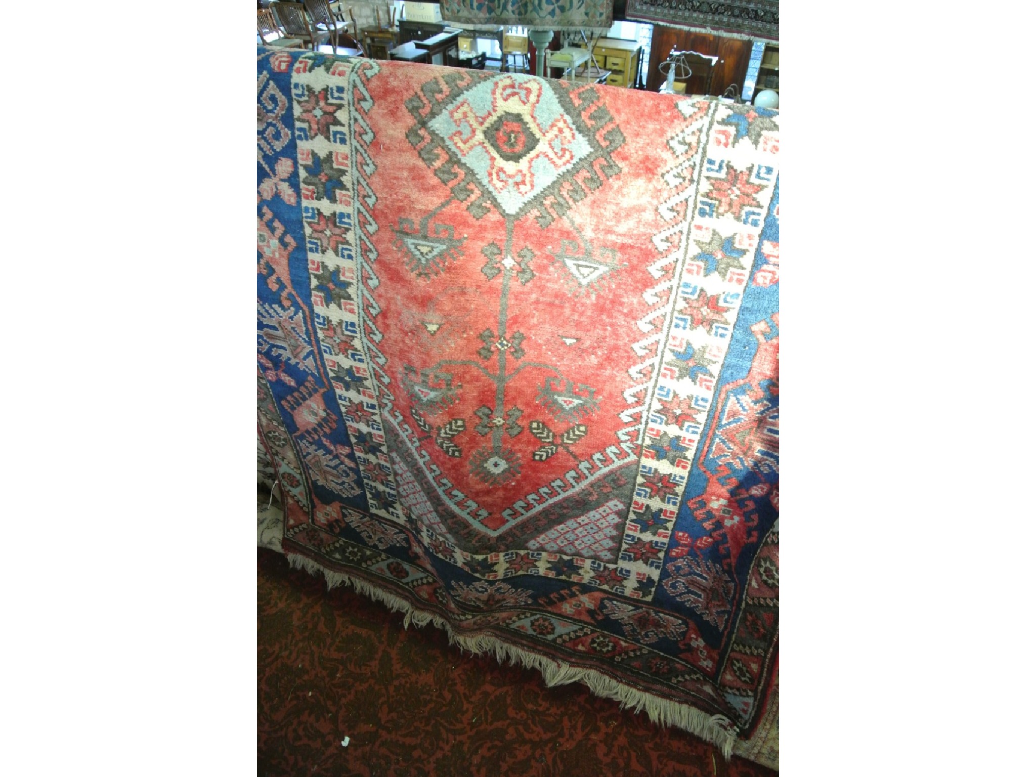 Appraisal: An Eastern wool rug the central red ground field within