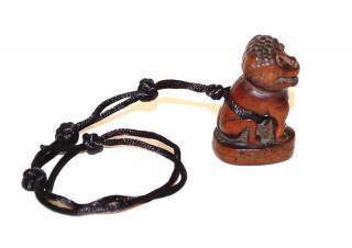 Appraisal: A Japanese Carved Wood Netsuke of a Buddhist Lion th