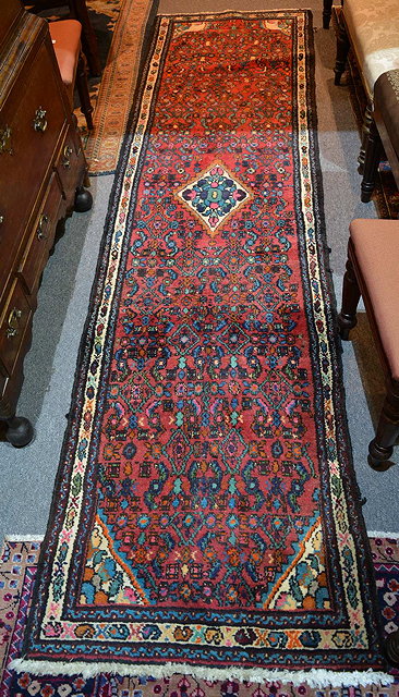 Appraisal: An Eastern wool runnerof red ground with geometric decoration and