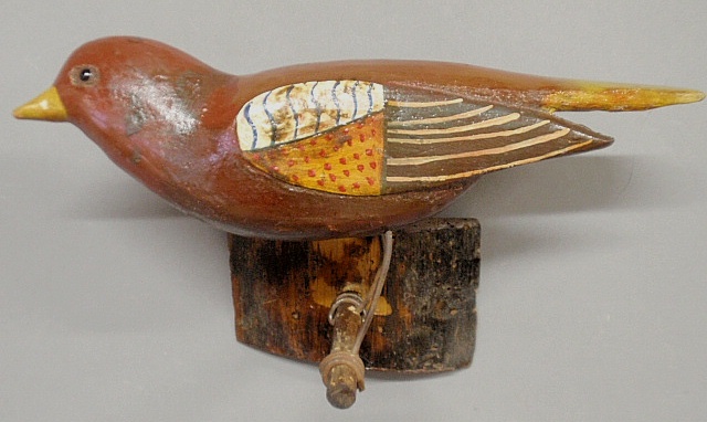 Appraisal: - Hanging folk art carved and paint decorated bird late