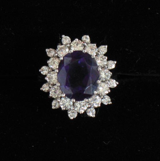 Appraisal: AN AMETHYST AND DIAMOND CLUSTER RING the central oval cushion-cut