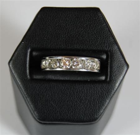 Appraisal: A platinum mounted diamond half-eternity ring channel set to the