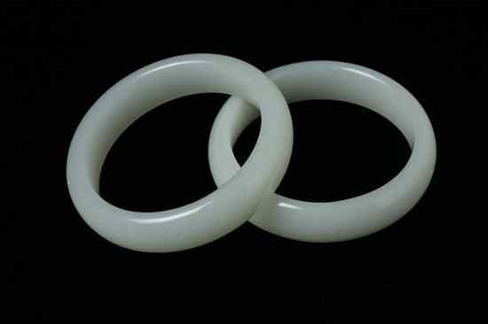 Appraisal: TWO CHINESE LIGHT CELADON JADE BANGLES - in diam